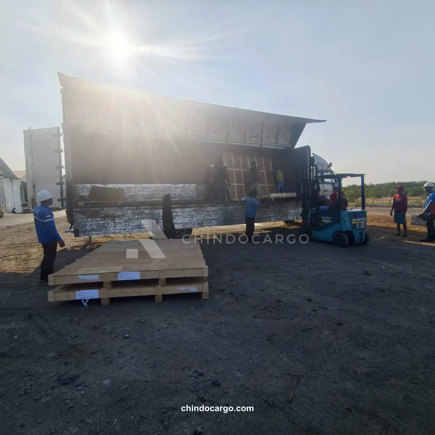 Forklift and cargo beside a truck