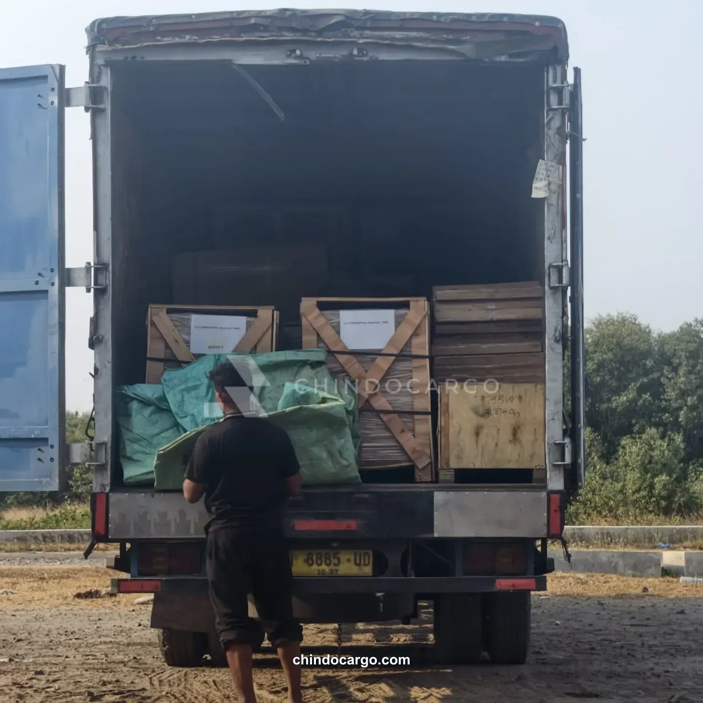 Loading wooden crates into a truck
